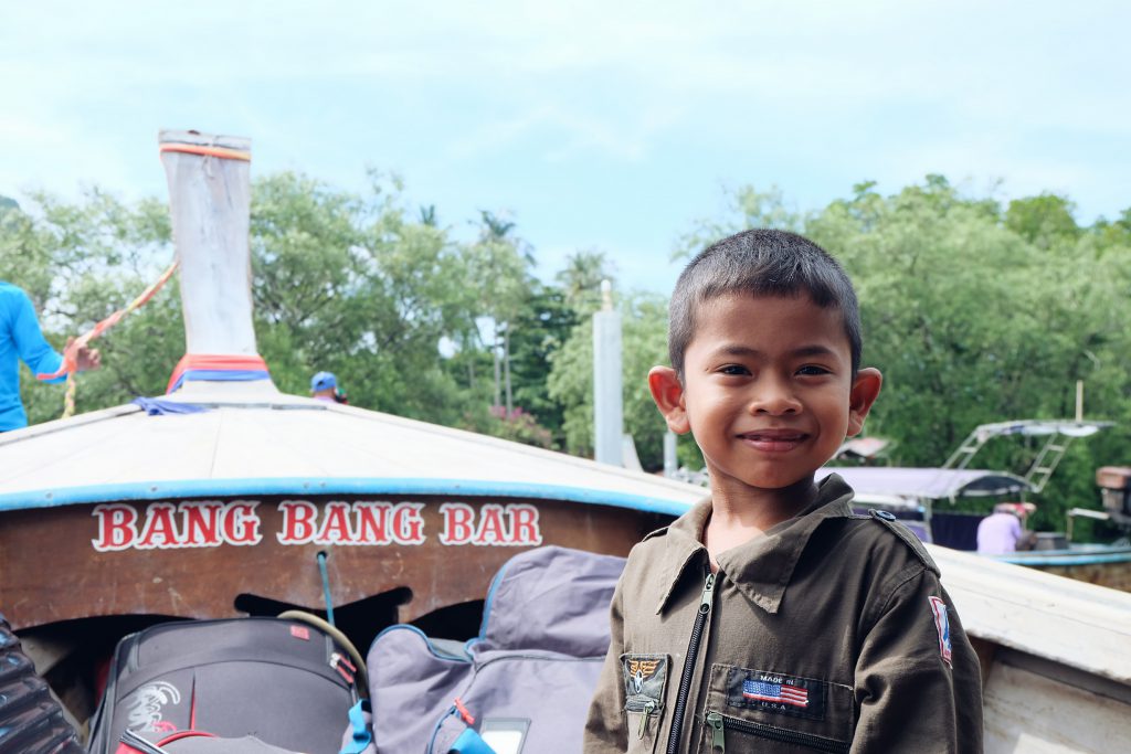 Thai kid on longtail boat Railay Beach Thailand